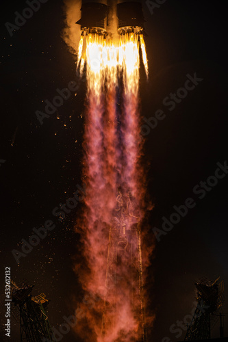 tele shot of a space rocket lift-off, bright flame