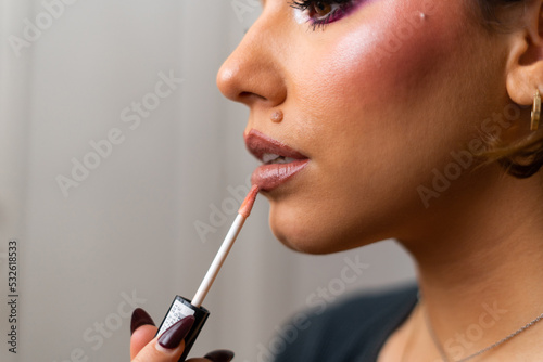 Woman painting her lips.
