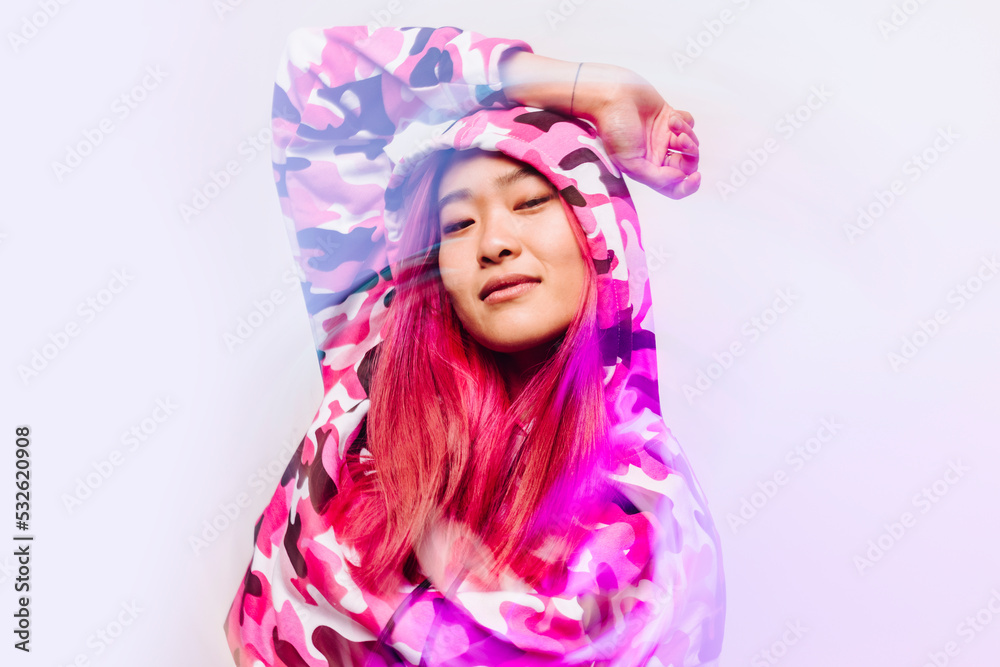 Cheerful chinese woman with colorful jacket looking at camera Cheerful chinese woman with colorful jacket looking at camera