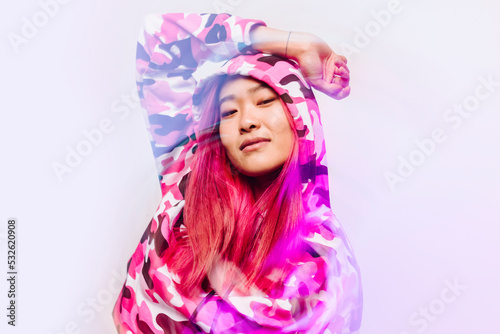 Cheerful chinese woman with colorful jacket looking at camera photo