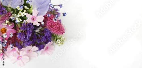 Bouquet of pink flowers on a white background. Festive flower arrangement. Background for a greeting card.