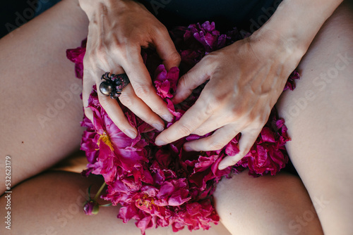 Anonymous woman touching gently bright pink flowers photo