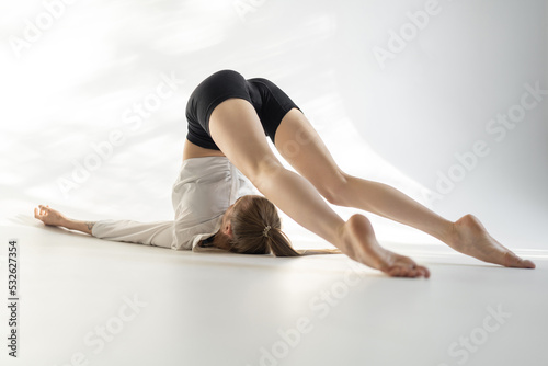 Female acrobat showing her capabilities in studio