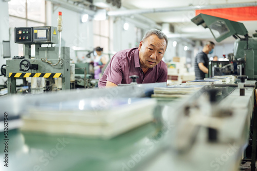 Factory worker in printing industry photo