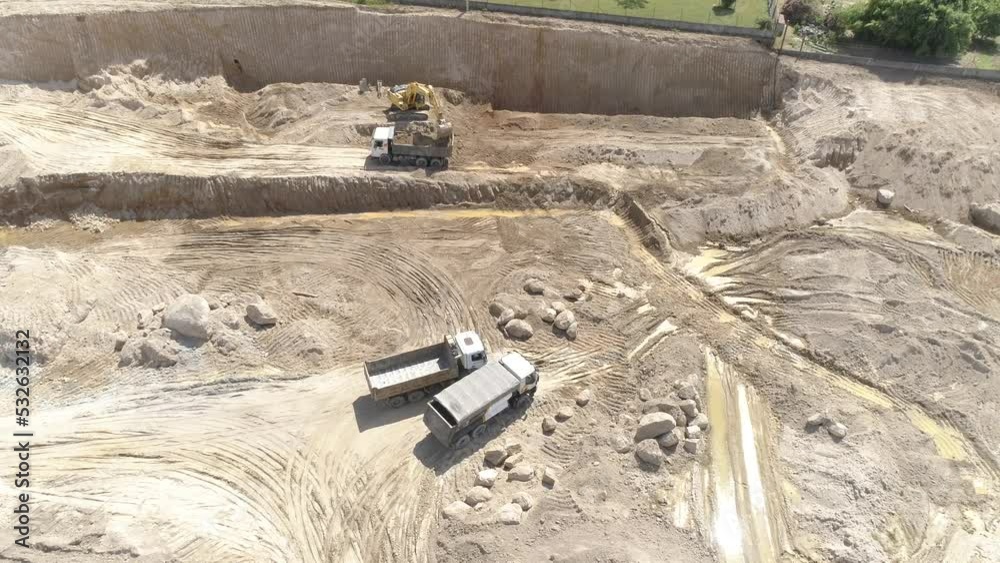 Trucks and Other Machines Working in the Construction Site Aerial View Trucks and Other Machines Working in the Construction Site Aerial View