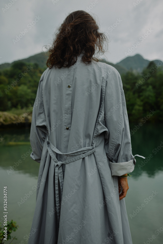 Anonymous woman in gray coat by the lake Anonymous woman in gray coat by the lake