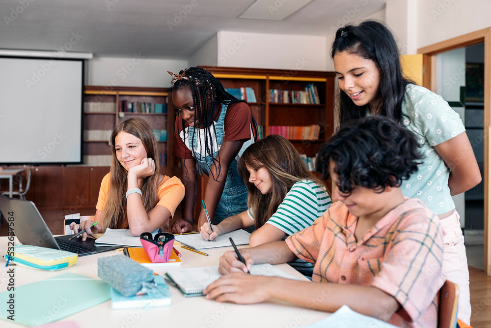 © Santi Nuñez/Stocksy - Teenagers studying