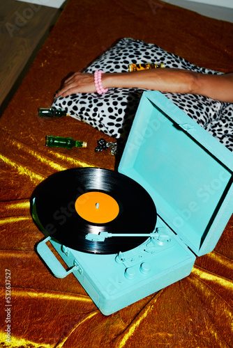 blue turntable and man lying down on the bed