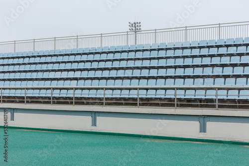 The sky blue stand in the stadium is empty. photo