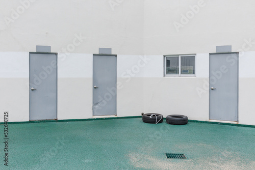 Close-up of the three gray doors on the wall. photo