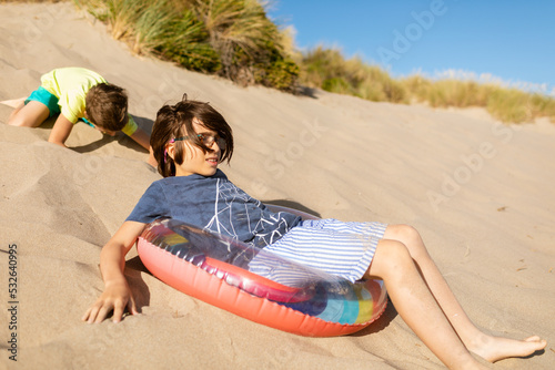 Two brothers playing by dunes