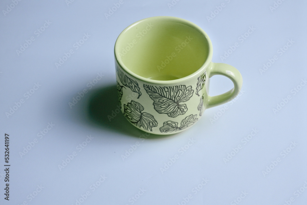 close up of yellow tea cup isolated in white background close up of yellow tea cup isolated in white background