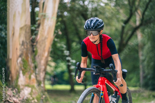 Sportswoman riding bicycle in countryside
