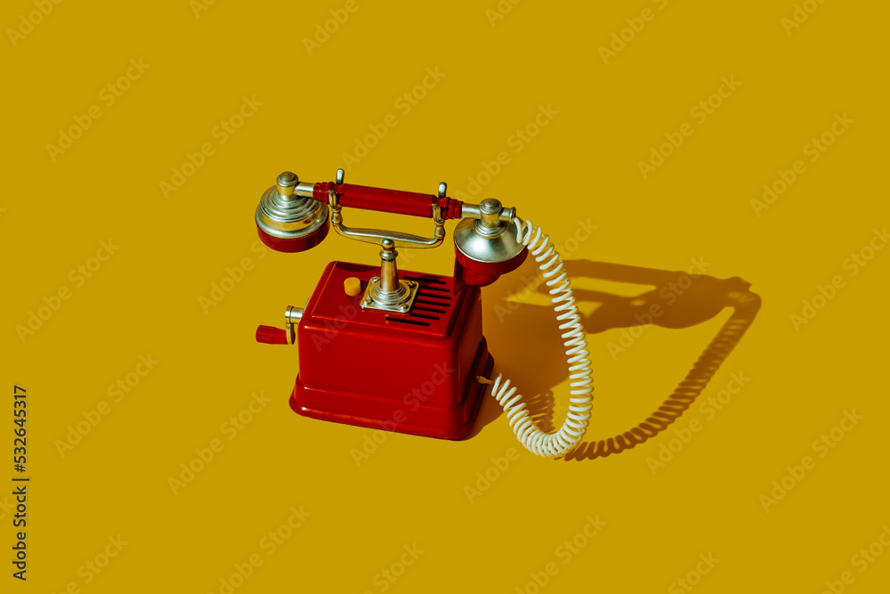 © Juan Moyano/Stocksy - old red telephone