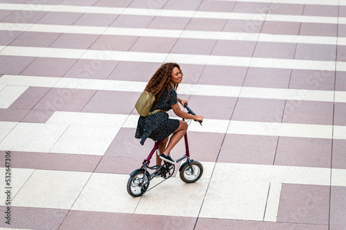 Black female riding bike on pavement photo
