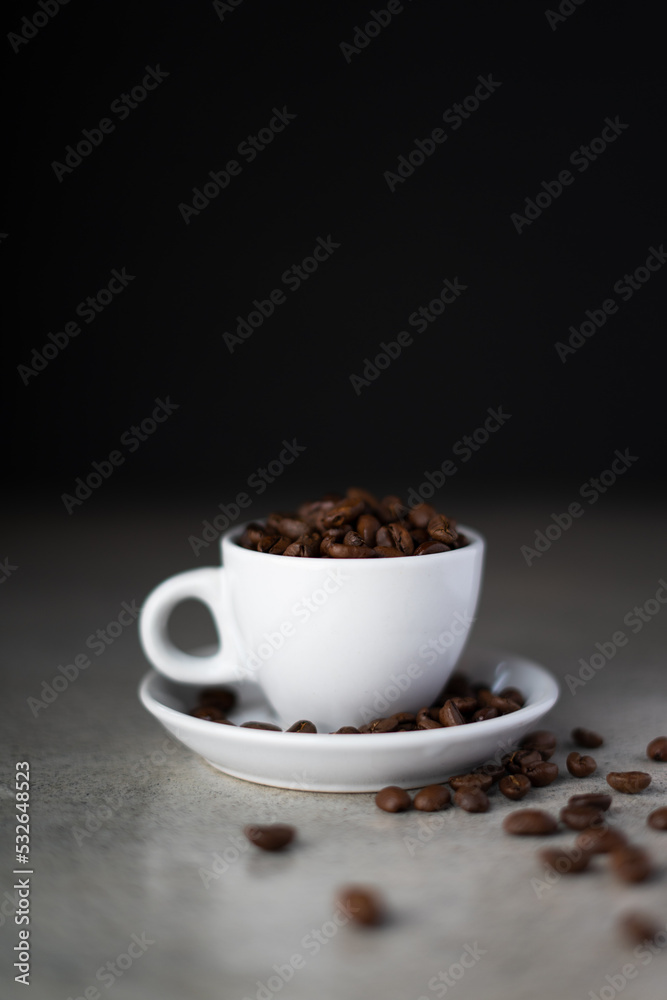 Obraz premium Cup of coffee beans on concrete counter top