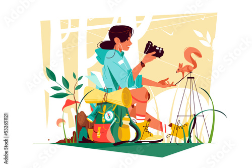 Photographer traveler, girl traveller making photos with squirrel