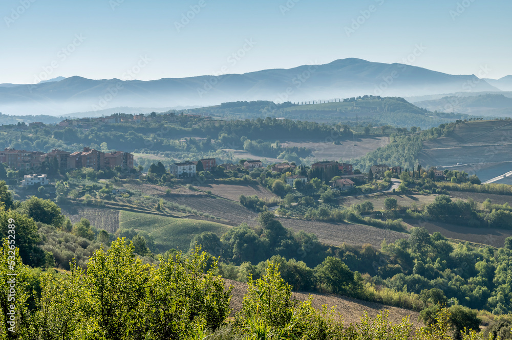 Panoramic view of the countryside of Todi, Perugia, Italy, partially shrouded in morning mist