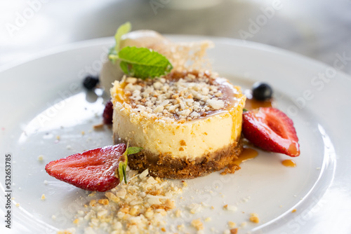 Cheesecake with toffee coconut milk, ginger cookies and strawberries. Gourmet food, sweet dessert concepts
