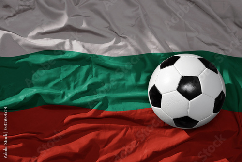 vintage football ball on the waveing national flag of bulgaria background. 3D illustration