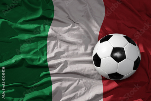 Photography vintage football ball on the waveing national flag of italy background