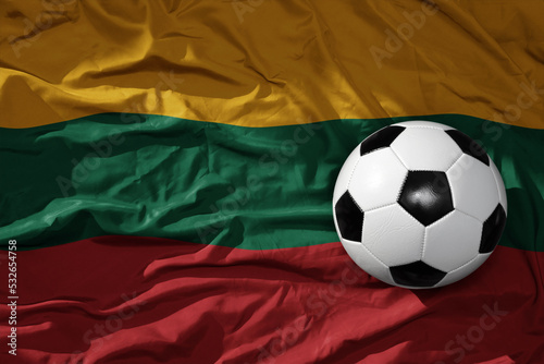 vintage football ball on the waveing national flag of lithuania background. 3D illustration