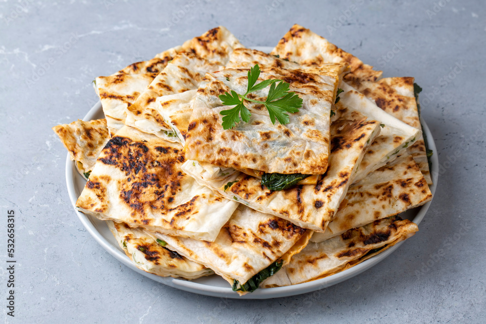 Traditional Turkish food, Turkish pancake gozleme with cheese and herb. The appetizer is Turkish pastry. There are varieties such as cheese, spinach, potato