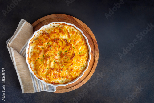 Potato gratin - graten (baked potatoes with cream and cheese) with rosemary and forks (Turkish name; Kremali patates) photo