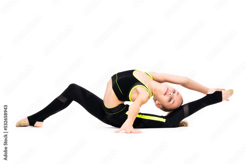 A little girl gymnast in a black sports gymnastic suit does acrobatic exercises isolated on a white background with space for text or logo. Flexibility and stretching - healthy lifestyle concept A little girl gymnast in a black sports gymnastic suit does acrobatic exercises isolated on a white background with space for text or logo. Flexibility and stretching - healthy lifestyle concept