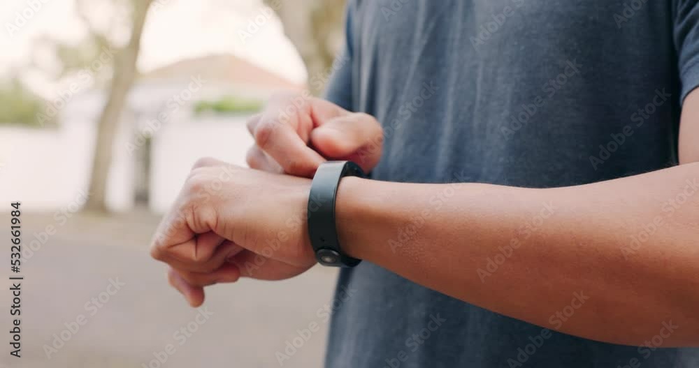 Exercise, health and smartwatch of a man training for a running marathon in an outdoor street. Closeup of a athlete with a healthy, wellness and active lifestyle setting his digital fitness wristband Exercise, health and smartwatch of a man training for a running marathon in an outdoor street. Closeup of a athlete with a healthy, wellness and active lifestyle setting his digital fitness wristband
