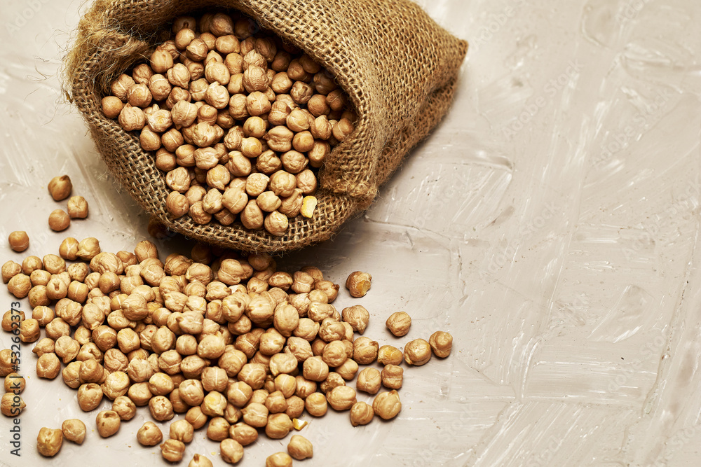 chickpeas in a canvas bag and scattered on the table