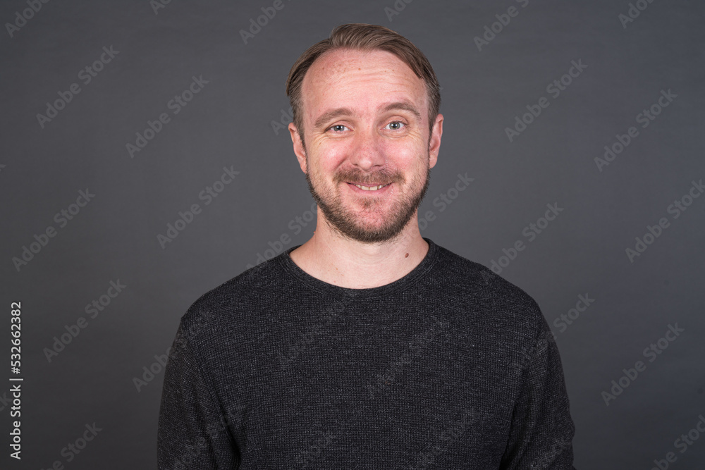 Studio portrait of blonde Caucasian man against gray background Studio portrait of blonde Caucasian man against gray background