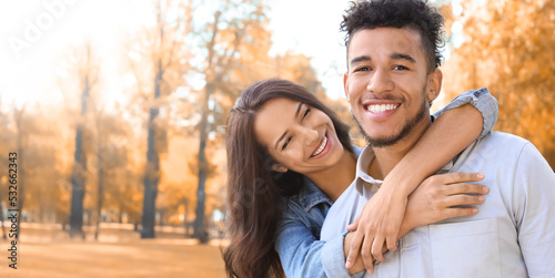 Happy young couple in park ...