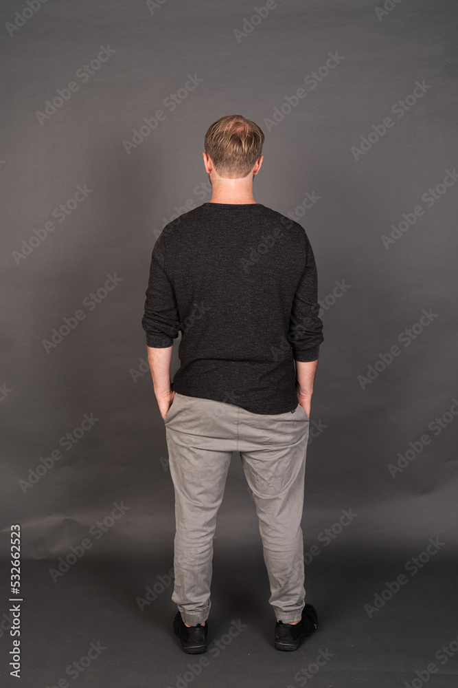 Studio portrait of blonde Caucasian man against gray background Studio portrait of blonde Caucasian man against gray background