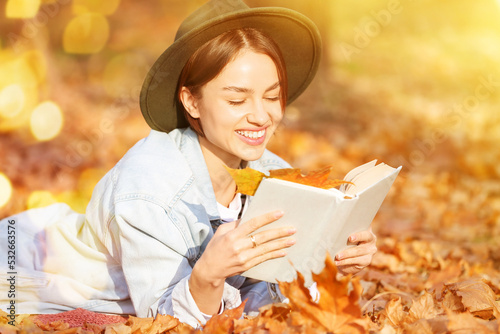 Pretty young woman reading ...