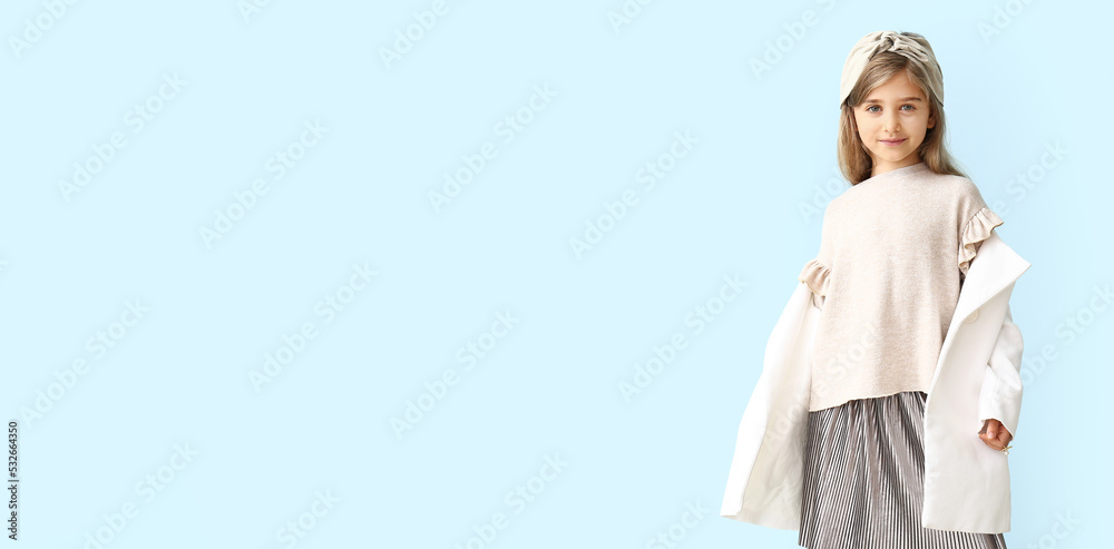 Stylish little girl in autumn clothes on light blue background with space for text Stylish little girl in autumn clothes on light blue background with space for text
