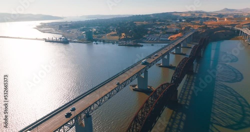 Beautiful sight of Martinez shore at the bay of California. Bridges with cars and trucks moving by. Sunny day aerial footage. photo