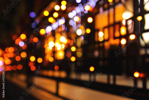 Blurred view of building with glowing lights at night © Pixel-Shot