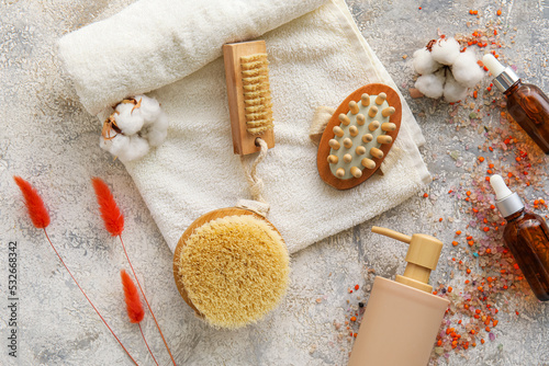 Composition with bath accessories and cosmetics on grunge background