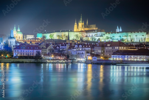 Hradcany quarter and Vltava river at night with blurred boat movement  Prague