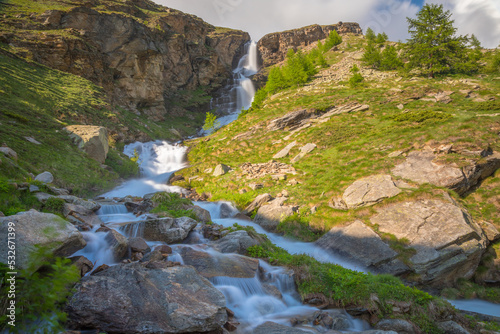 Ethereal waterfall and alpine meadows at springtime  Gran Paradiso Alps  Italy