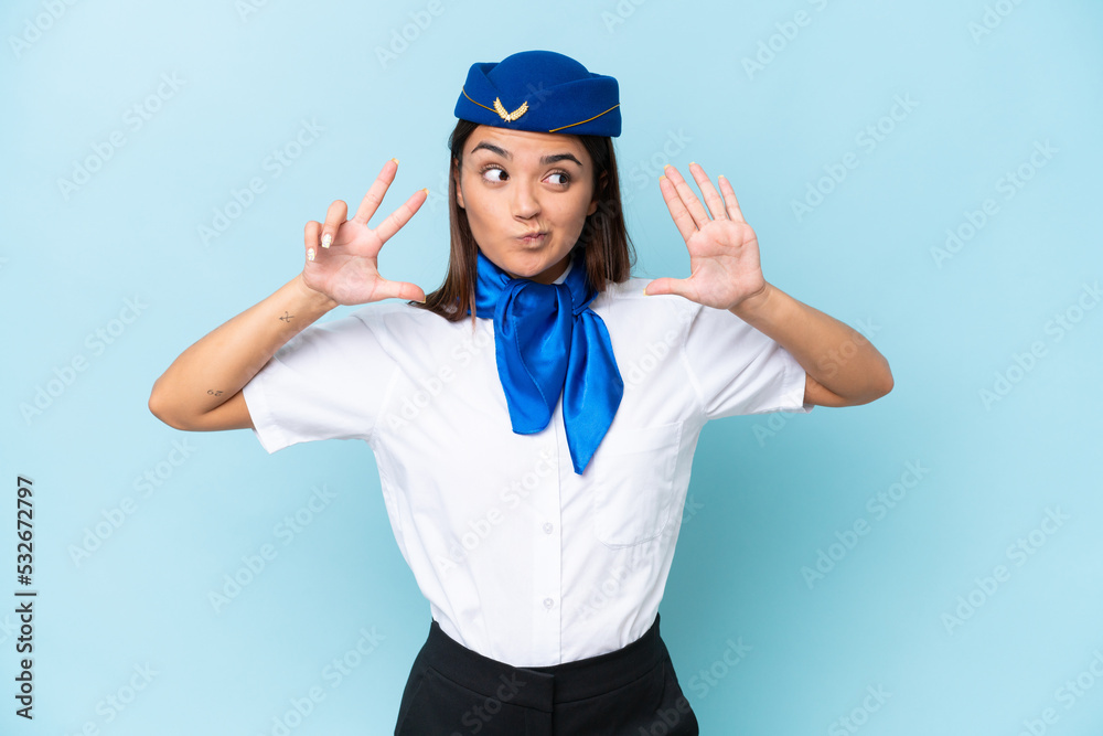Airplane stewardess caucasian woman isolated on blue background counting eight with fingers Airplane stewardess caucasian woman isolated on blue background counting eight with fingers