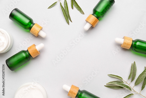 Bottles of essential olive oil on white background