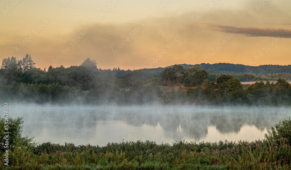 Fototapeta premium Sunrise in Danish. Mist and haze, with dramatic clouds