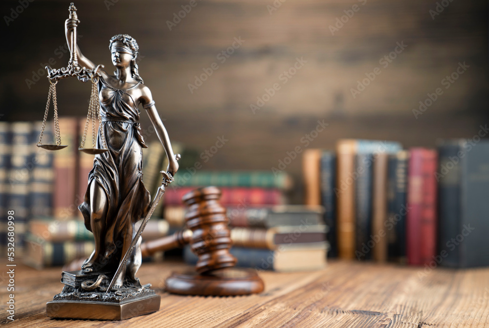 Law theme - judge office. Themis sculpture  and legal books on the judge desk.  - obrazy, fototapety, plakaty 