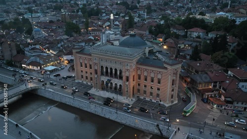 Aerial footage timelapse or hyperlapse of Sarajevo City Hall, National Library in the old town, destroyed in Serbian aggression 1992. Orbiting shot.  photo