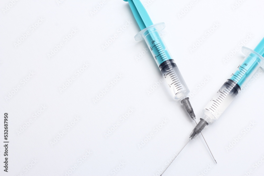 Medical syringe on a white background. A syringe for injection. The concept of health and beauty Medical syringe on a white background. A syringe for injection. The concept of health and beauty