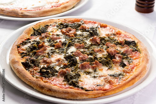 best italian pizza with sausage and vegetables  photo