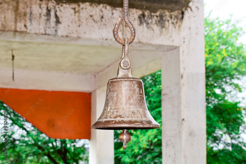 Fototapeta premium Ringing the old bell in the temple, golden metal old bell