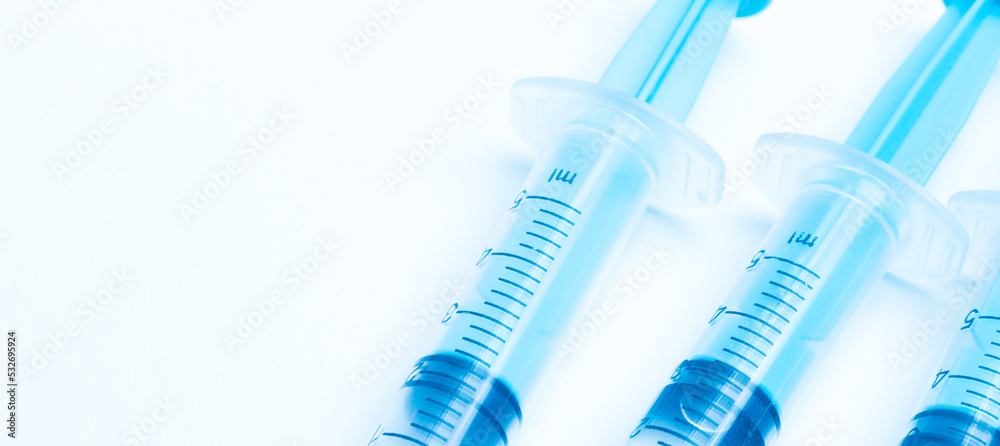 medical disposable syringe with needle for injection in the hospital. medical devices on a white background. virus protection concept medical disposable syringe with needle for injection in the hospital. medical devices on a white background. virus protection concept